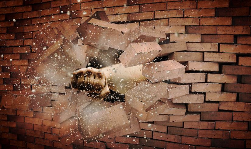 fist punching through a brick wall