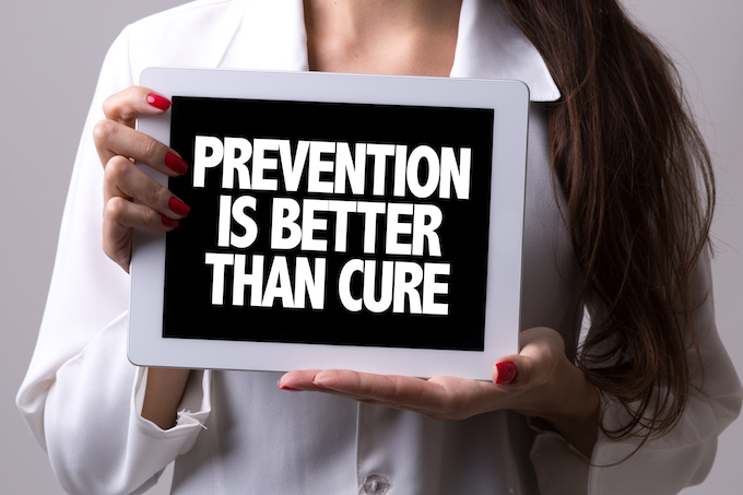Female doctor holding a tablet with the text: Prevention is Better Than Cure